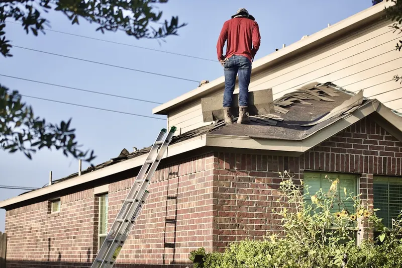 Professional roofer working on a residential roof in Pilot